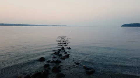 Stones at the ocean. Romantic Sunset with reflection on the water 스톡 동영상 114972372