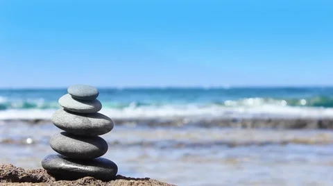 Stones pyramid on the beach. Ocean in the background Stock Footage 44121394