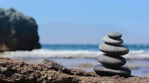 Stones pyramid on the beach. Ocean in the background 스톡 동영상 44121443