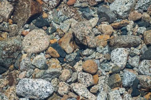 Stones in river of different shape and colors, closeup. Foto stock