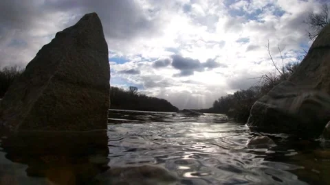 Stones on the river, sun rays, cloudy, time laps 스톡 동영상 165516610