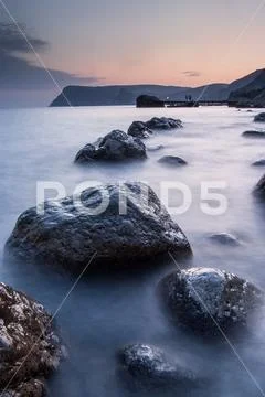 Stones in the sea on a long exposure Stock Photos