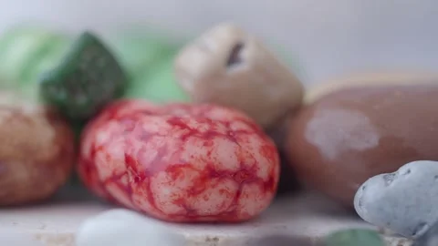 Stones shape colorful chocolate candy macro shot slow motion rotating on wh.. Stock Footage 332263390