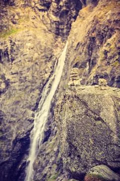 Stones stack and waterfall in mountains, Norway Stock Photos