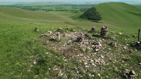 Stones stacked in pyramids on the mountain range chests in khakassia Stock Footage 157447518