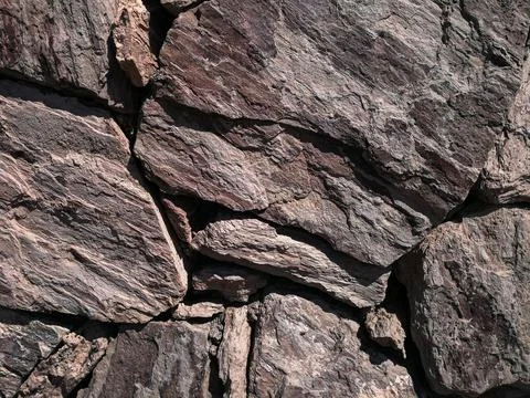 Stones stacked to a wall - structures as background Stock Photos