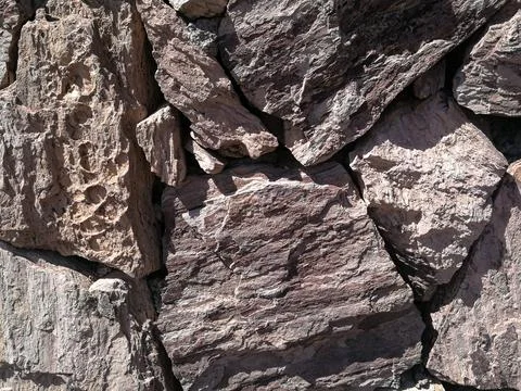 Stones stacked to a wall - structures as background Stock Photos