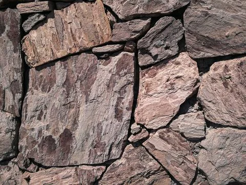 Stones stacked to a wall - structures as background Stock Photos