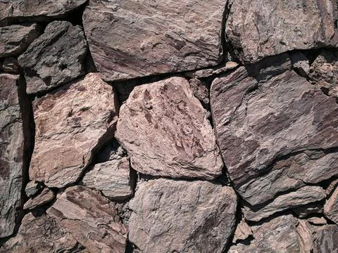 Stones stacked to a wall - structures as background Stock Photos