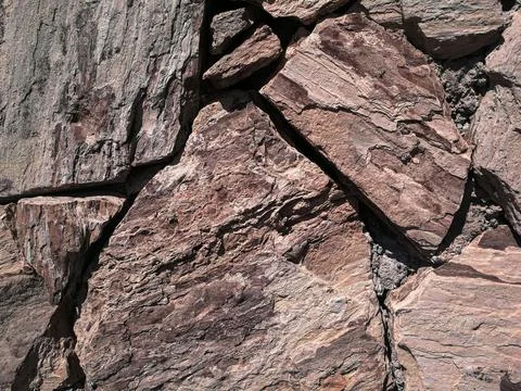 Stones stacked to a wall - structures as background Stock Photos