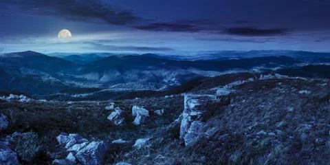 Stones in valley on top of mountain range at night Stock Photos