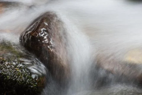 Stones in the water from a brook Stock Photos