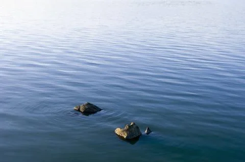 Stones in water surface Stock Photos