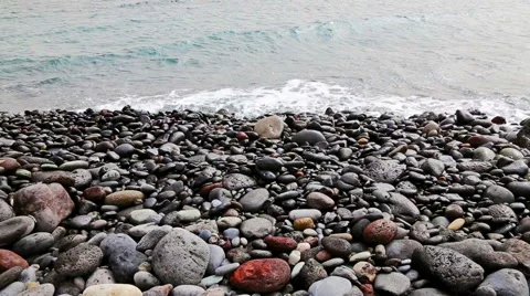 Stones with waves on beach of shore or coast of ocean or sea Stock Footage 49673582