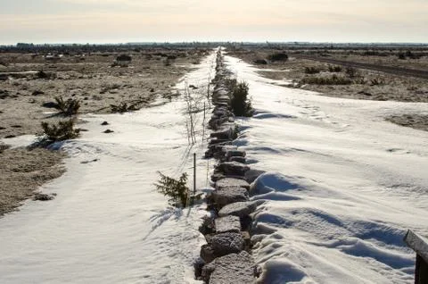 Stonewall with snowdrift Stock Photos
