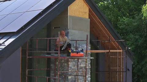 Stonework Construction on a House With Solar Panels Stock Footage 276691532