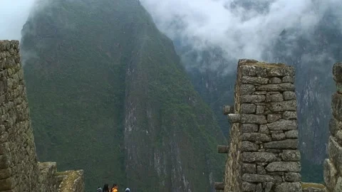 Stonework of Machu Picchu. Mist, mountains and vegetation in background. Video stock 305313326
