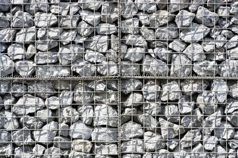 Stonework, under iron wire. Stock Photos