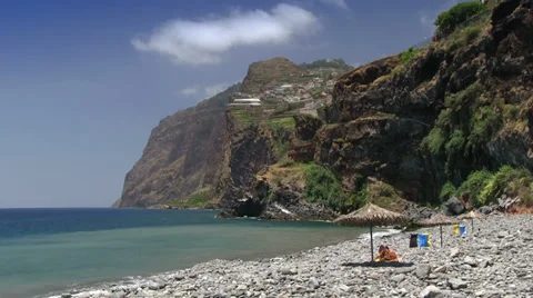Stony beach in Camara de Lobos, view of the Cabo Girao cliff, Madeira, Portugal Stock Footage 32593280