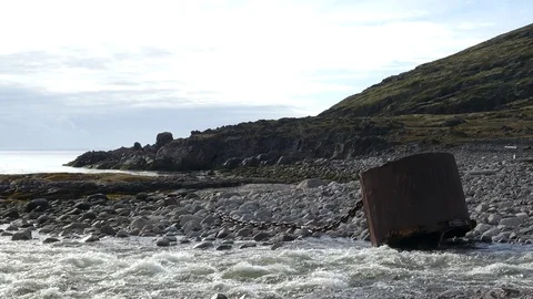 Stony shore, a rushing river flows into the bay. Stock Footage 81727092