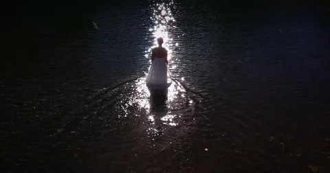 Stood up bride entering to the lake Stock Footage 91417235