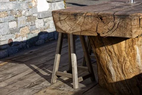 Stool and tables made from a single wooden trunk in a cottage Stock Photos