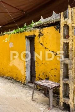 Stool bright yellow building doorway and awning Stock Photos