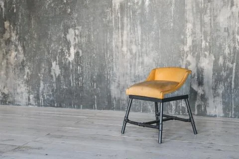 Stool on concrete wall background. Loft room. Wooden floor. daylight. Free space Stock Photos