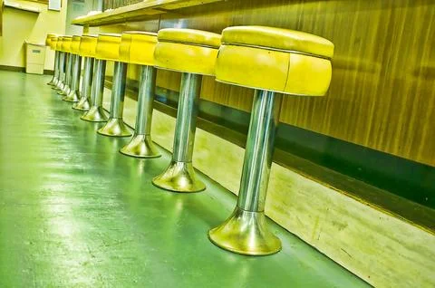Stools at an old lunch counter Stock Photos
