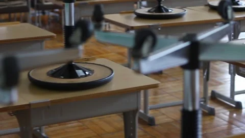 Stools on top of school desks Stock Footage 245808359