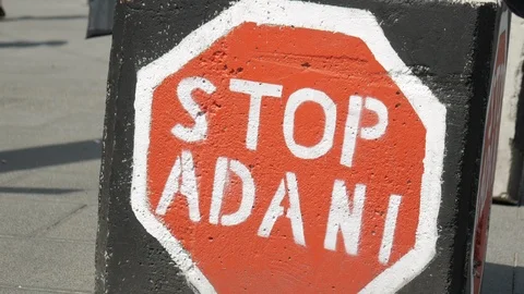 Stop Adani protest sign painted on the bollards in Melbourne, Australia. Stock Footage 104428348