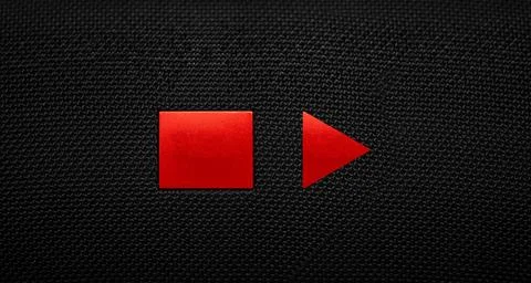 Stop and Play button on a black textile background. Video player. Foto stock