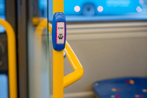 Stop button on yellow pole inside public bus for passenger convenience Photos