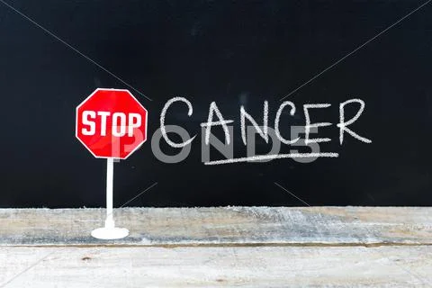 STOP CANCER message written on chalkboard Stock Photos