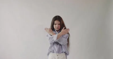 Stop concept: virus, violence, abortion, inequality, plastic. Girl crossed arms Stock Footage 137973596