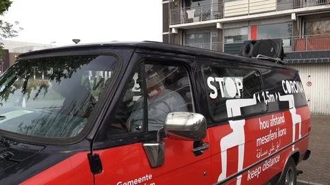 Stop corona keep distance message on government van Amsterdam Netherlands Stock Footage 130081290