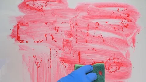 Stop coronavirus concept. hand in blue rubber glove washes glass from red paint Stock Footage 128807794
