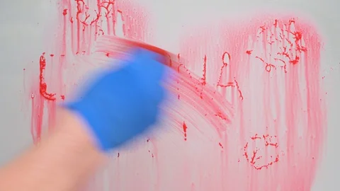 Stop coronavirus concept. hand in blue rubber glove washes glass from red paint Stock Footage 128807811