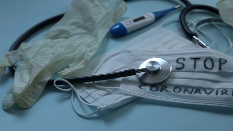 Stop Coronavirus text on surgical protective mask ,doctor gloves,thermometer Stock Footage 127337744