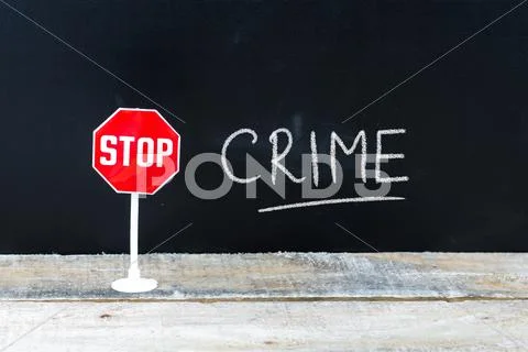 STOP CRIME message written on chalkboard Stock Photos