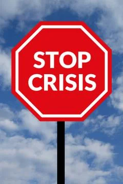 Stop crisis. Text on red traffic stop sign in rear of cloudy blue sky. Stock Photos