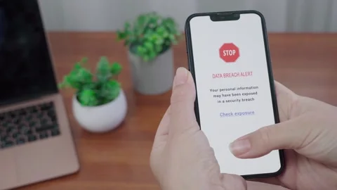 Stop Data Breach AI Notification on Phone in Workspace Stock Footage 341396861