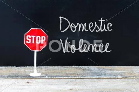 STOP DOMESTIC VIOLENCE message written on chalkboard Stock Photos