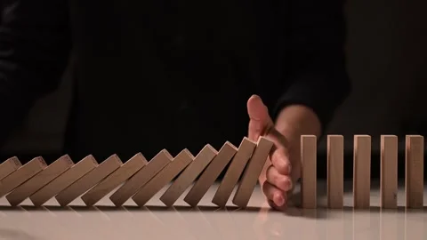 Stop Domino falling By Hand, front view Stock Footage 293334279