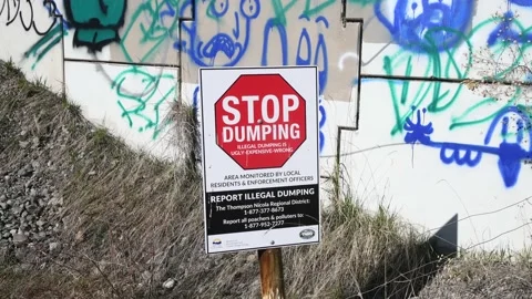 STOP dumping signage and graffitti on highway overpass, cu, 4k Stock Footage 153429982
