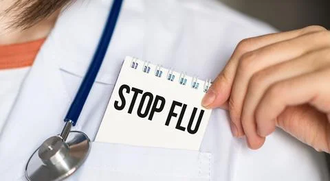 Stop Flu text on white card in hand doctor taking it out of his pocket Stock Photos