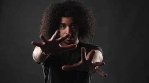 Stop Gesture And Boundary Setting Concept, Young Man With Afro Hair Extending Stock Footage 335934587