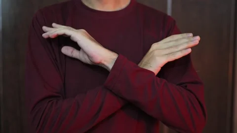 STOP hand gesture The guy shows a denial gesture with his hands. No, stop 库存影片 337847587