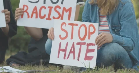 Stop hate placard in female hands close-up. Unrecognizable young Caucasian Video stock 138238501
