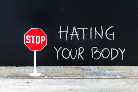 STOP HATING YOUR BODY message written on chalkboard Stock Photos